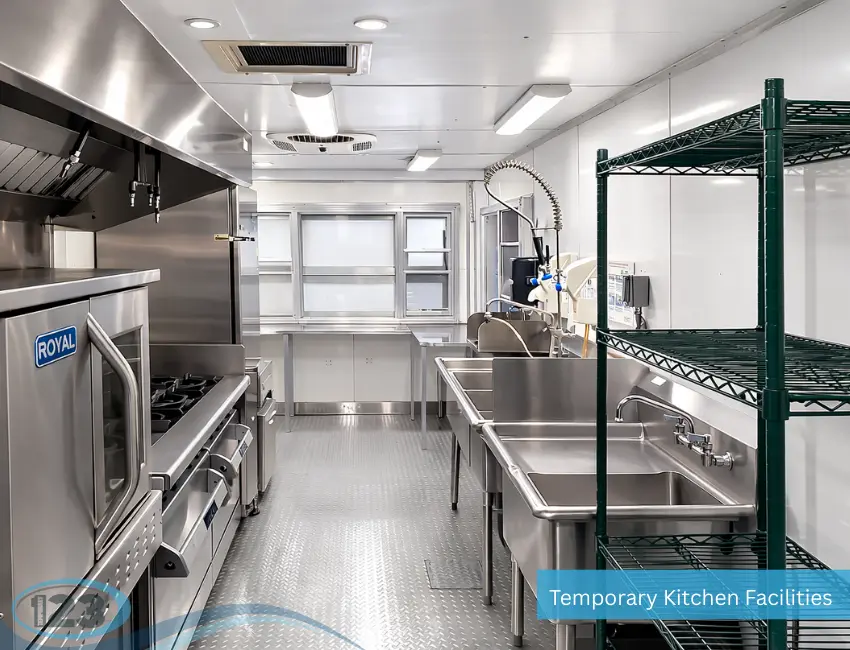 Temporary kitchen interior featuring food preparation area and racks